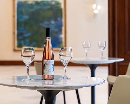 Bottle of ros&eacute; wine with two glasses in the CordeValle Winery tasting room